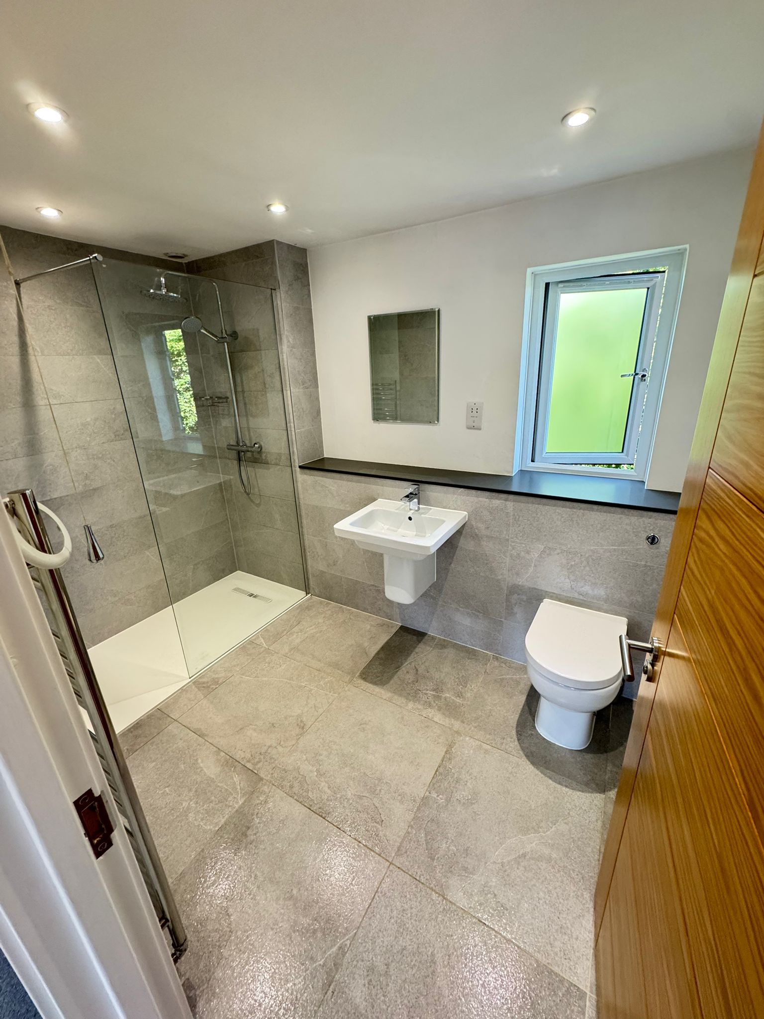 Grey tiled bathroom cleaned